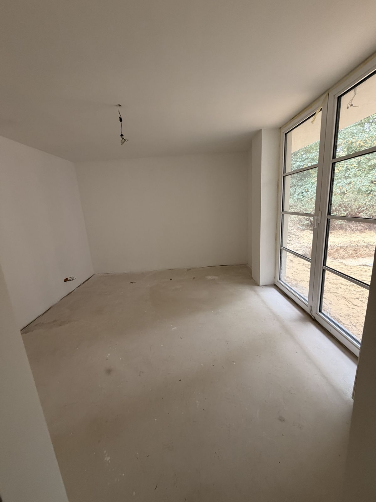 Chambre avec chape nue avant la pose du parquet